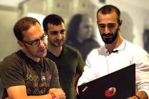 Dave, Stav, and Costa looking at the laptop
